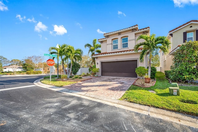 mediterranean / spanish-style home with a garage