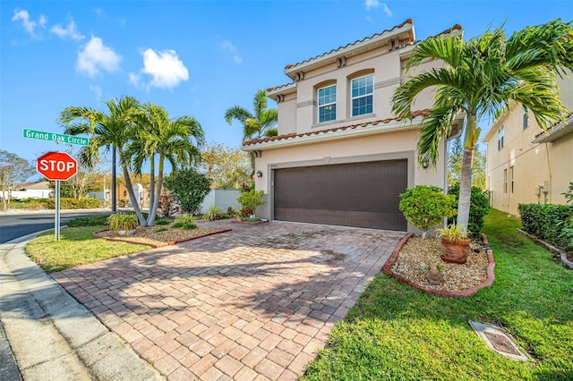 mediterranean / spanish-style house featuring a front lawn and a garage