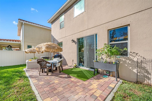 back of house featuring a yard and a patio