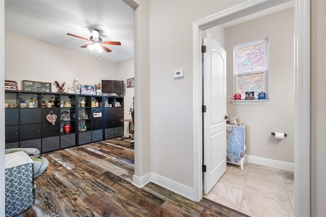 interior space with ceiling fan and a textured ceiling