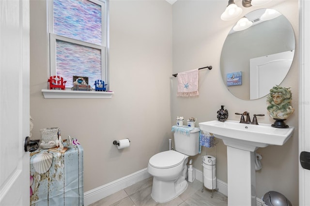 bathroom with tile patterned flooring and toilet