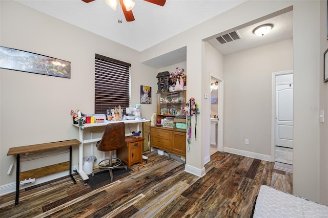 office featuring a textured ceiling, ceiling fan, and dark hardwood / wood-style floors