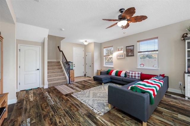 living room featuring a textured ceiling, dark hardwood / wood-style flooring, and ceiling fan