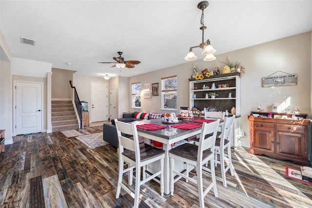 dining room featuring a textured ceiling, dark hardwood / wood-style flooring, and ceiling fan