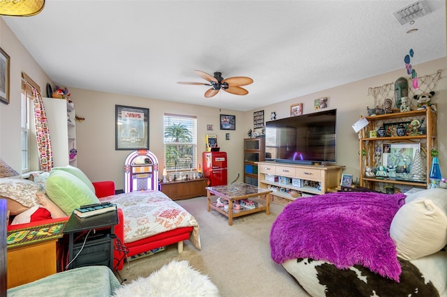 bedroom with carpet flooring, a textured ceiling, and ceiling fan