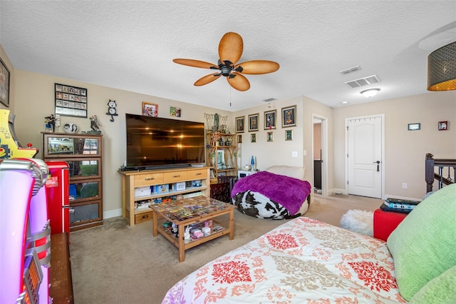 bedroom with ceiling fan, light carpet, and a textured ceiling