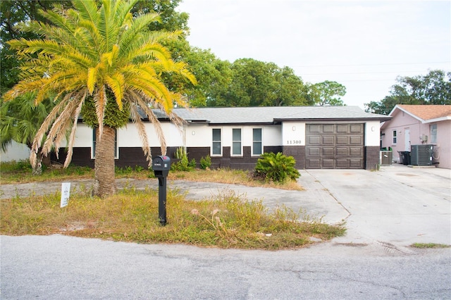 11300 Yellowwood Ln, Port Richey, FL 34668 - ranch-style house featuring central AC and a garage