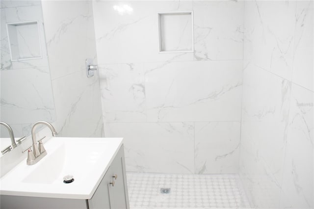 bathroom featuring vanity and tiled shower