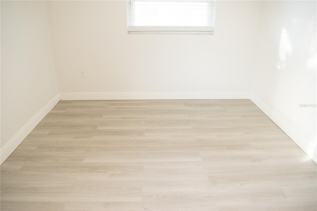 spare room featuring light hardwood / wood-style flooring