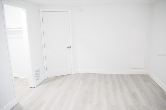 spare room with light hardwood / wood-style floors