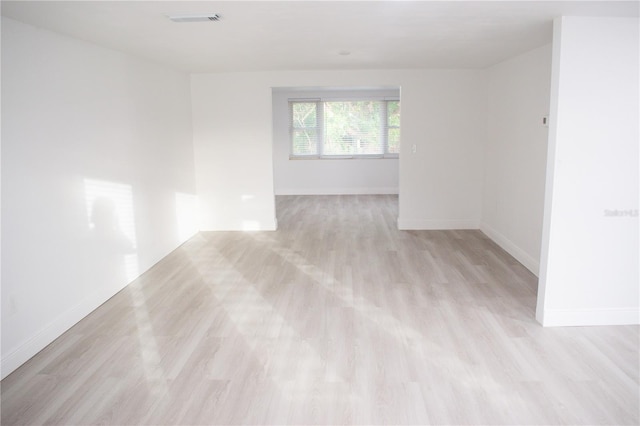 spare room featuring light wood-type flooring