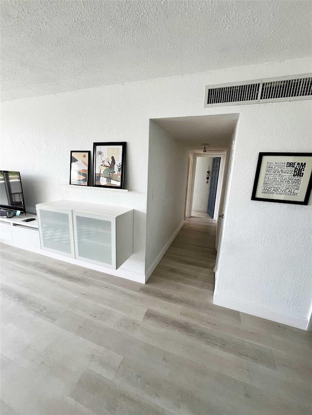 470 3rd St S Unit 405, Saint Petersburg, FL 33701 - hall with a textured ceiling and wood finished floors