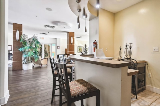 bar with dark hardwood / wood-style flooring