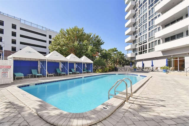 view of swimming pool featuring a patio area