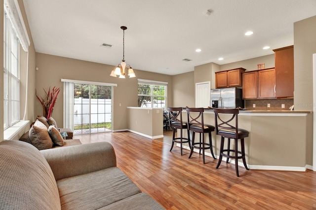 living room featuring light hardwood / wood-style floors and an inviting chandelier