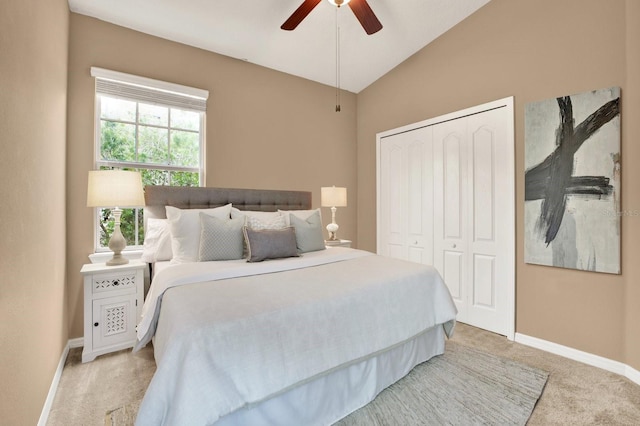 bedroom featuring light carpet, a closet, vaulted ceiling, and ceiling fan