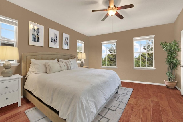 bedroom with hardwood / wood-style flooring and ceiling fan