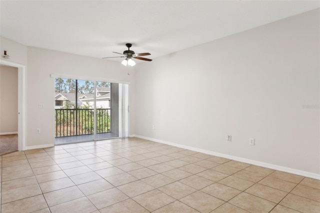 tiled spare room with ceiling fan