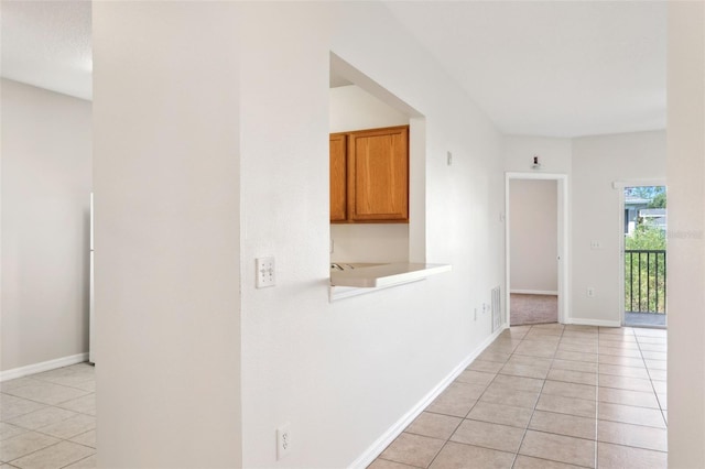 corridor featuring light tile patterned flooring