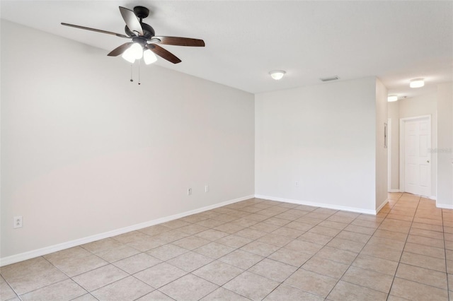 tiled empty room featuring ceiling fan