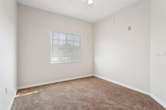 carpeted empty room featuring ceiling fan