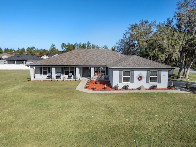 back of property featuring a lawn