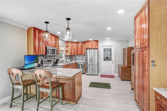 kitchen with kitchen peninsula, a kitchen bar, tasteful backsplash, stainless steel appliances, and sink