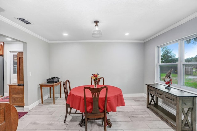 dining space with ornamental molding