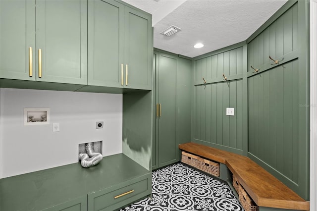 clothes washing area with cabinet space, visible vents, hookup for a washing machine, a textured ceiling, and electric dryer hookup