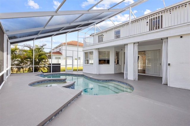 view of pool with a patio area, a lanai, and a pool with connected hot tub