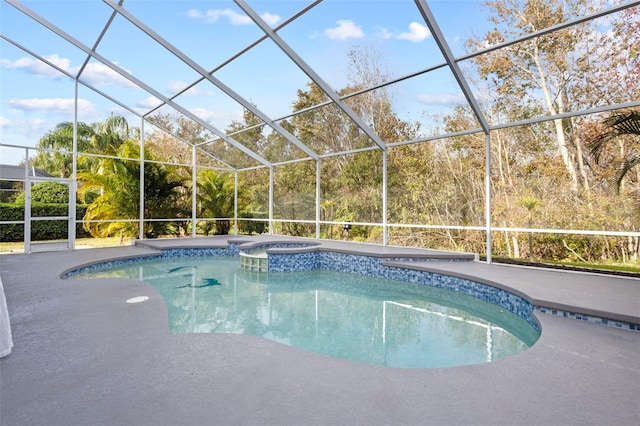 view of pool with a lanai, a pool with connected hot tub, and a patio