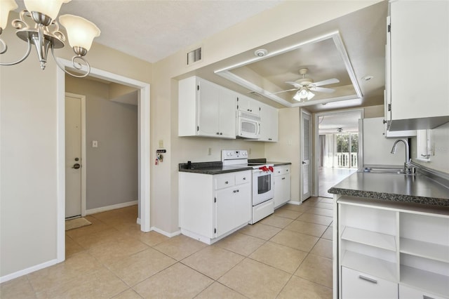 kitchen featuring sink, white cabinetry, a raised ceiling, white appliances, and ceiling fan with notable chandelier