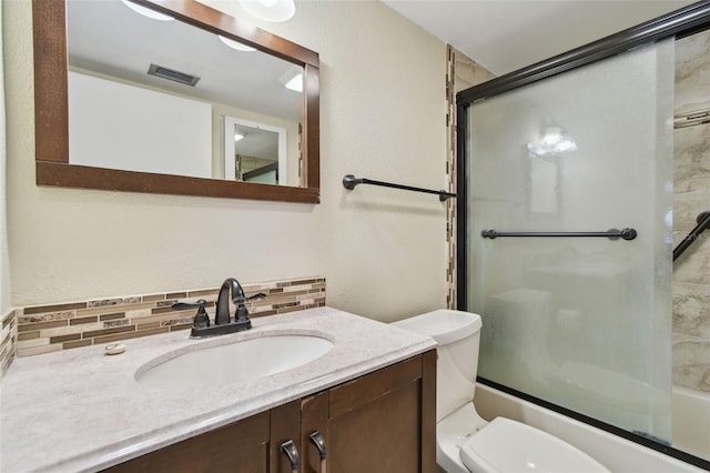 full bathroom with vanity, backsplash, enclosed tub / shower combo, and toilet