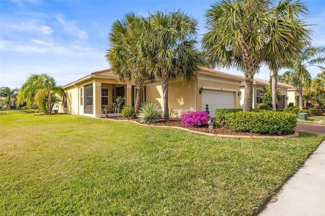 mediterranean / spanish-style house featuring a front yard and a garage