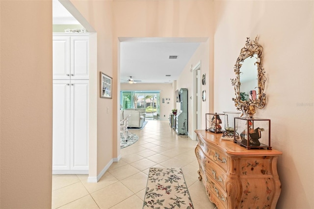 hall featuring light tile patterned flooring