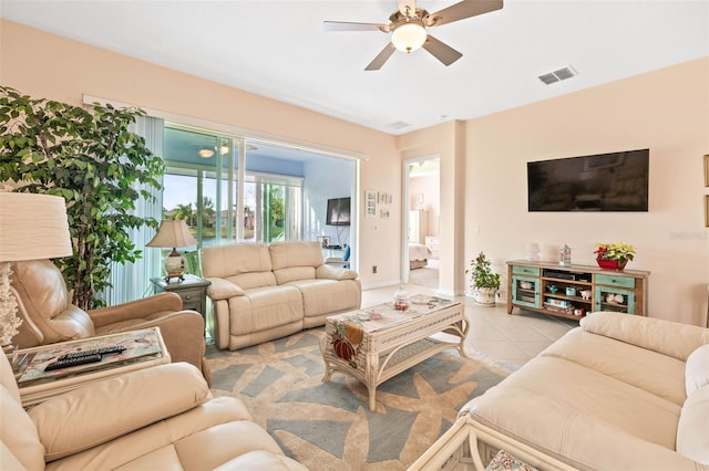 living room with light tile patterned floors and ceiling fan