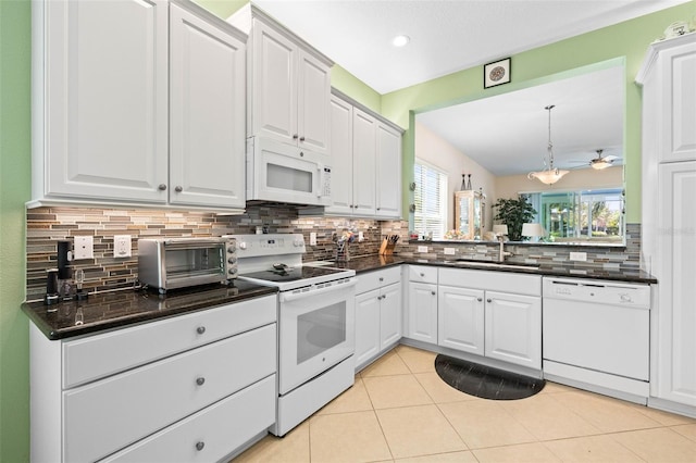 kitchen with ceiling fan, sink, backsplash, white appliances, and white cabinets