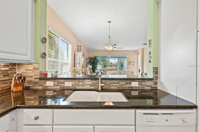 kitchen with white cabinetry, dishwasher, hanging light fixtures, and plenty of natural light