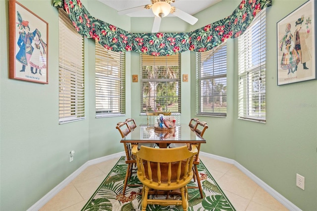 tiled dining room with ceiling fan and a healthy amount of sunlight