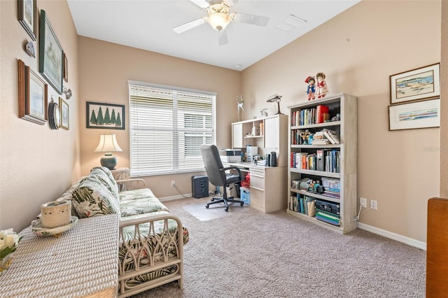 carpeted home office featuring ceiling fan