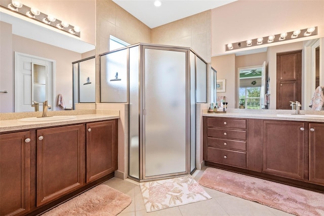 bathroom featuring tile patterned floors, vanity, and walk in shower