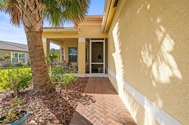 view of exterior entry featuring a patio area