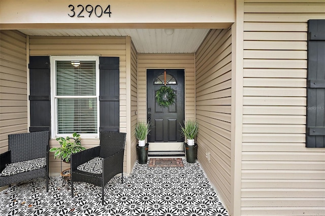 view of exterior entry featuring a porch