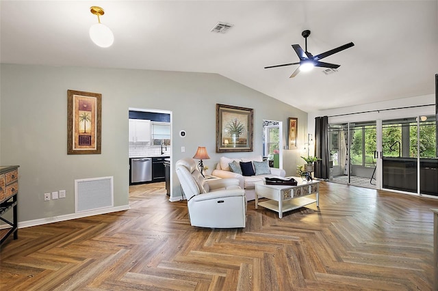 living room with ceiling fan, parquet floors, and vaulted ceiling