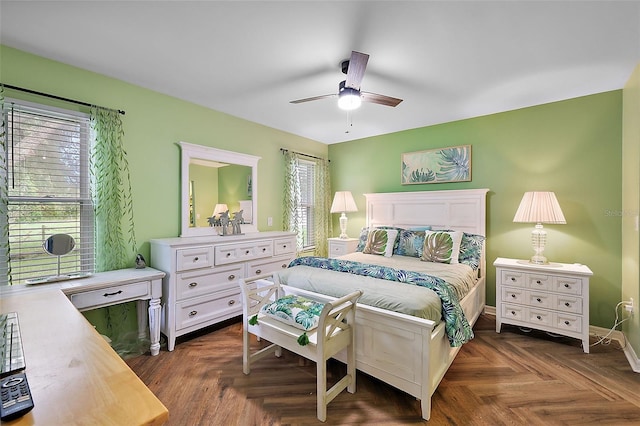 bedroom featuring ceiling fan and dark parquet floors