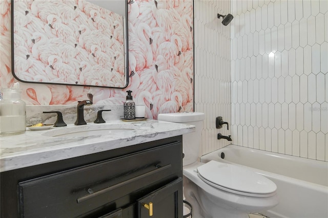 full bathroom featuring washtub / shower combination, vanity, and toilet