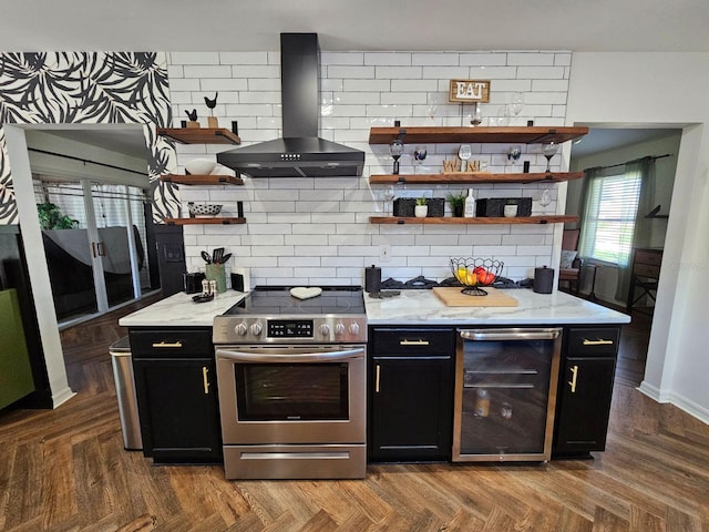 kitchen with parquet flooring, tasteful backsplash, island range hood, stainless steel range oven, and wine cooler