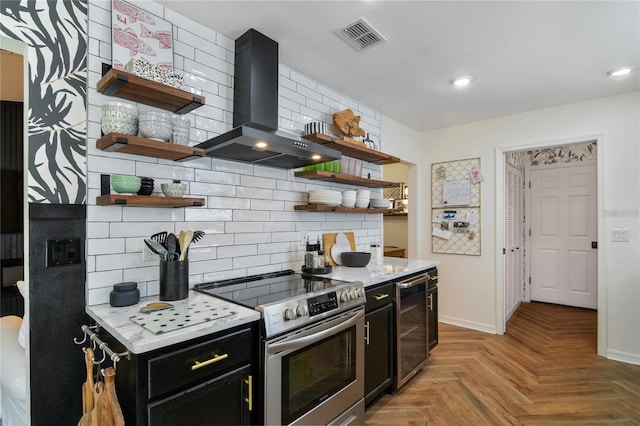 kitchen featuring stainless steel range with electric cooktop, light parquet floors, wine cooler, wall chimney exhaust hood, and tasteful backsplash