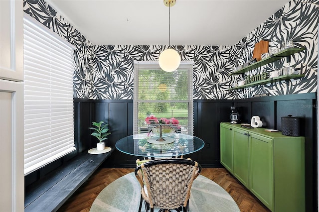 dining area featuring dark parquet flooring