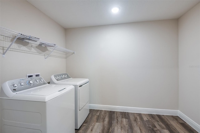 washroom featuring dark wood-type flooring and independent washer and dryer